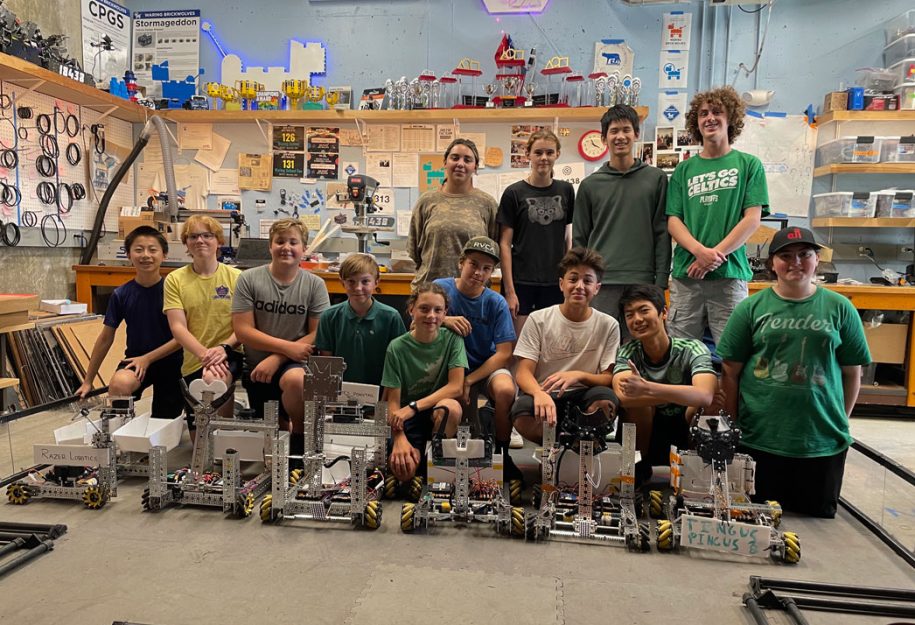 FTC Robotics, students posing with their robots